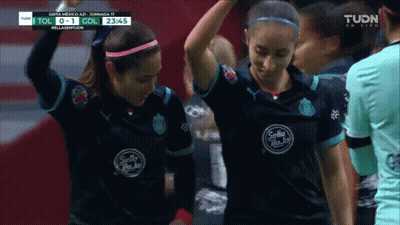 Two Female Soccer Players Wearing Black Sello Shirts GIF