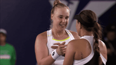 Two Female Tennis Players Are Hugging And One Has A Tattoo On Her Back That Says ' I Love You ' GIF