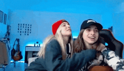 Two Female Wrestlers On Stage With Kai On Wall GIF
