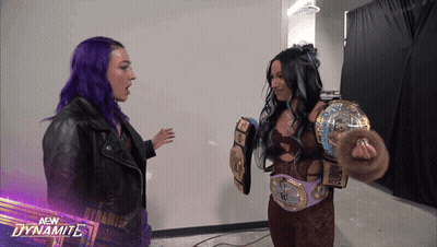 Two Female Wrestlers With New Dynamite Logo Background