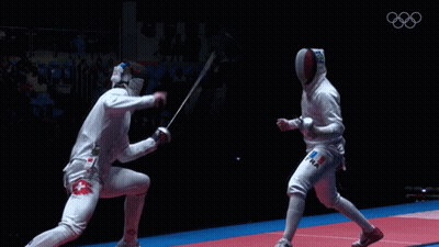 Two Fencers Are Fighting Each Other With The Olympics Logo In The Background GIF
