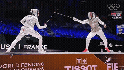 Two Fencers Are Fighting In Front Of A Tissot Sign GIF
