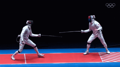 Two Fencers Are Fighting On A Red And Blue Mat With The Olympics Logo In The Background GIF