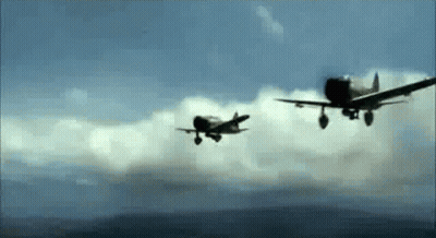 Two Fighter Planes Are Flying In The Sky . GIF