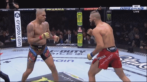 Two Fighters Are Fighting In A Ring With A Crypto.com Banner On The Side GIF