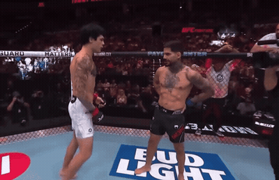 Two Fighters In A Boxing Ring With A Bud Light Advertisement On The Floor GIF