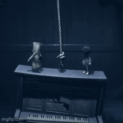 Two Figurines Standing On Piano In Dark Room GIF