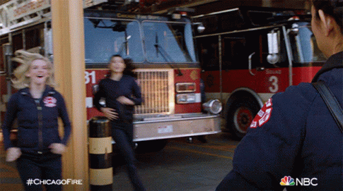 Two Firefighters In Front Of Fire Truck With Number 3 GIF