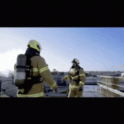 Two Firefighters Standing On Roof GIF