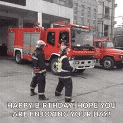 Two Firefighters Talking In Front Of Fire Truck GIF