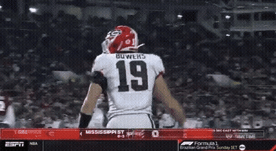 Two Football Players Are Celebrating A Touchdown During A Game On Espn GIF