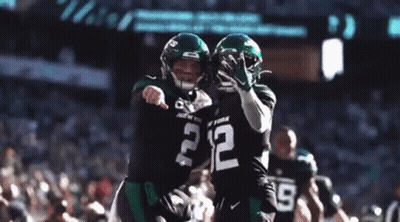 Two Football Players Are Hugging Each Other And One Has The Number 2 On His Jersey GIF