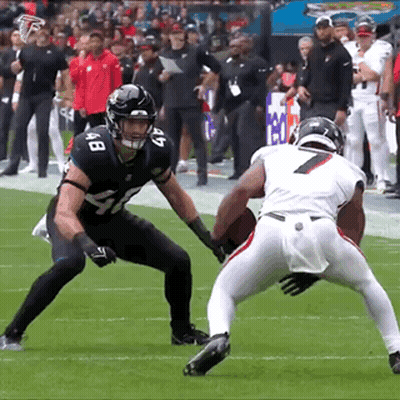 Two Football Players Are Playing A Game And One Has The Number 7 On His Shirt GIF