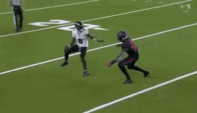 Two Football Players Are Playing A Game On A Field . One Of The Players Is Wearing A Number 8 Jersey . GIF