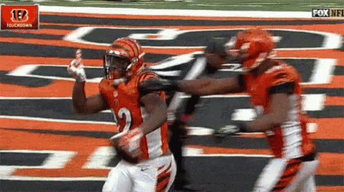 Two Football Players Are Running On A Field With A Fox Nfl Logo In The Background GIF