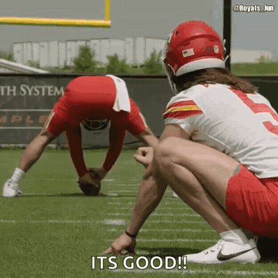 Two Football Players Are Squatting On The Field And One Of Them Says It 'S Good GIF