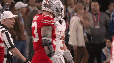 Two Football Players Are Standing Next To Each Other And One Has The Number 5 On His Jersey GIF