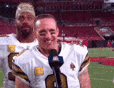 Two Football Players Are Standing On A Field And One Of Them Is Wearing A Number 9 Jersey GIF