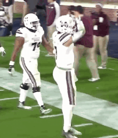 Two Football Players Are Standing On The Field And One Has The Number 7 On His Shirt GIF