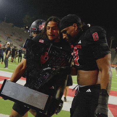 Two Football Players Carrying Trophy Number 5