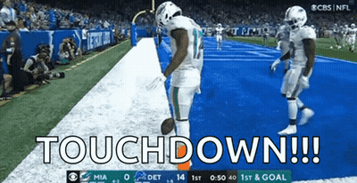 Two Football Players Celebrate A Touchdown During A Game Between The Miami Dolphins And Detroit Lions GIF