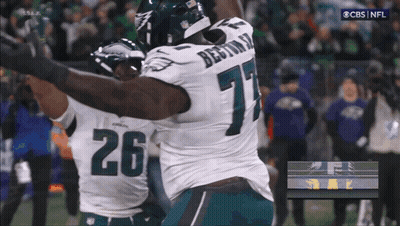 Two Football Players Hugging Number 26 GIF