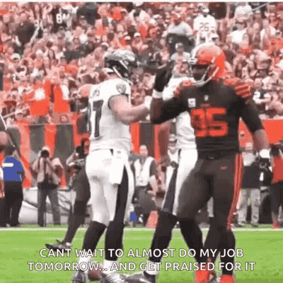 Two Football Players Hugging Number 35 Jersey GIF