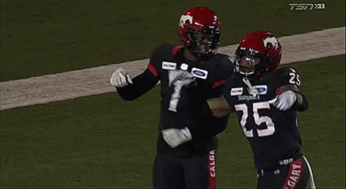 Two Football Players Hugging On Field GIF