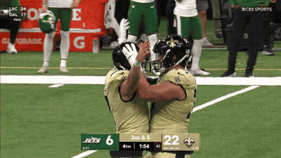 Two Football Players Hugging On Field With 3Rd & 5 Scoreboard GIF