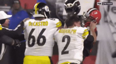 Two Football Players Hugging, One With Number 35 Jersey GIF