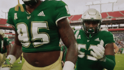 Two Football Players In Green Jerseys Number 55 GIF