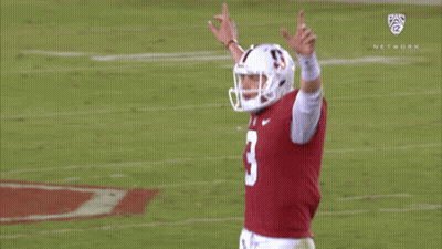 Two Football Players In State Jerseys Dancing By Tree GIF