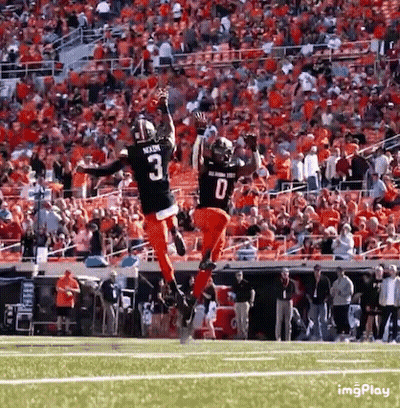 Two Football Players Jumping In Air GIF