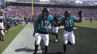 Two Football Players Number 12 And 51 GIF