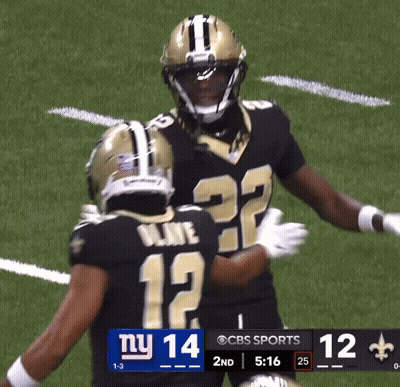 Two Football Players On A Field With A Scoreboard That Says Ny 14 GIF