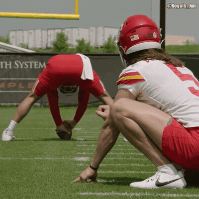 Two Football Players On Field With System Sign GIF