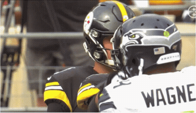 Two Football Players One In Wagner Jersey Talking GIF