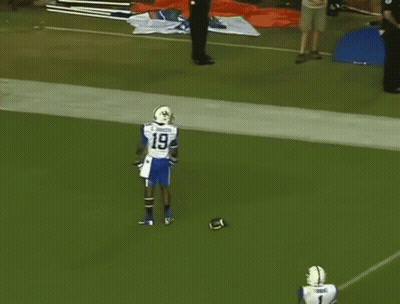 Two Football Players One Of Whom Is Wearing Number 1 GIF