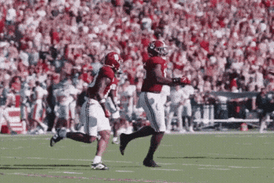Two Football Players Running On Field GIF