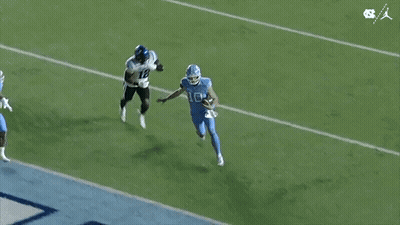 Two Football Players Running On Field GIF