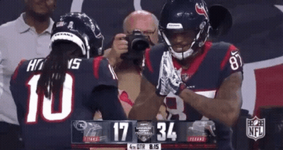 Two Football Players Standing On Field GIF