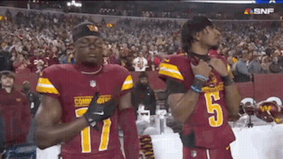 Two Football Players Standing On Field GIF