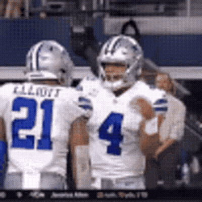 Two Football Players Standing On Field GIF