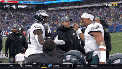 Two Football Players Talking On Field GIF