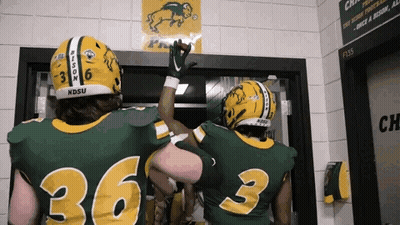 Two Football Players Wearing Green And Yellow Uniforms With The Numbers 36 And 3 GIF