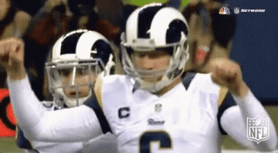 Two Football Players Wearing Helmets And Jerseys With The Letter C On Them GIF