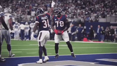 Two Football Players Wearing Jerseys With The Number 31 And 78 Are Celebrating On The Field . GIF