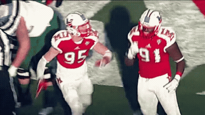 Two Football Players Wearing Red And White Uniforms With The Number 95 On Them GIF