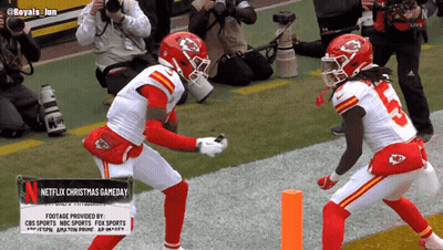 Two Football Players With Netflix Christmas Gameday Sign GIF