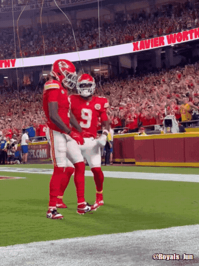 Two Football Players With Xavier Worth Banner GIF